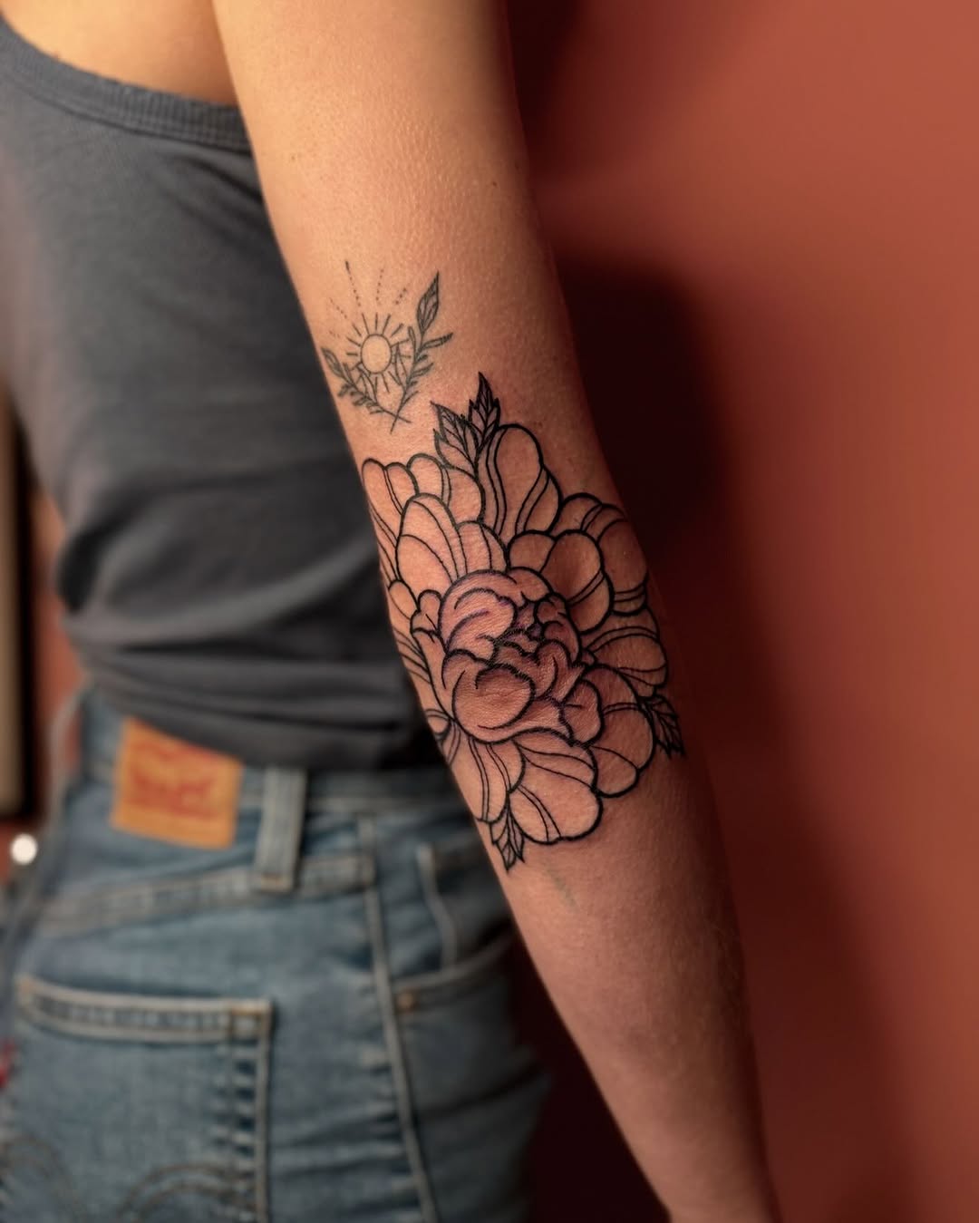 Elegant floral elbow tattoo with subtle shading