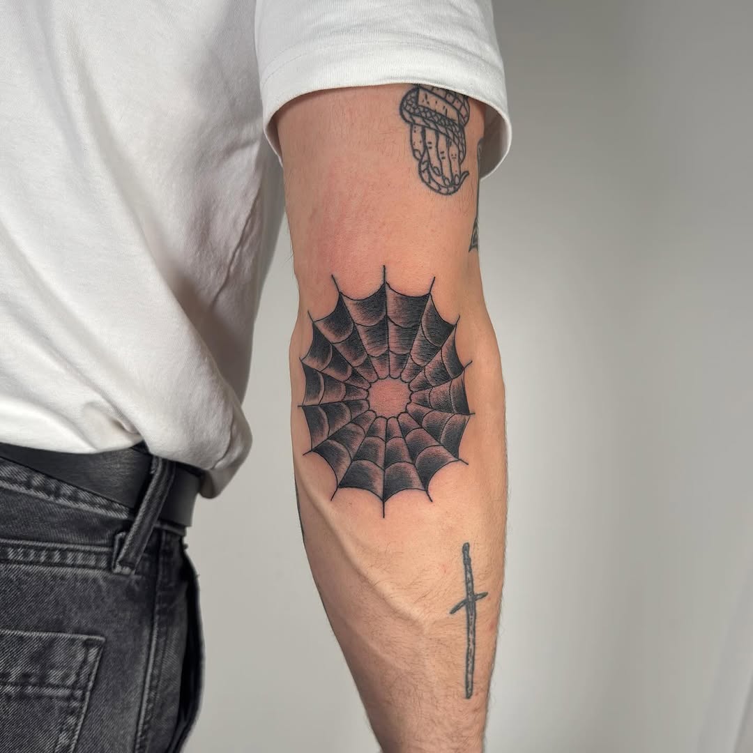 Stylish spider web tattoo on elbow