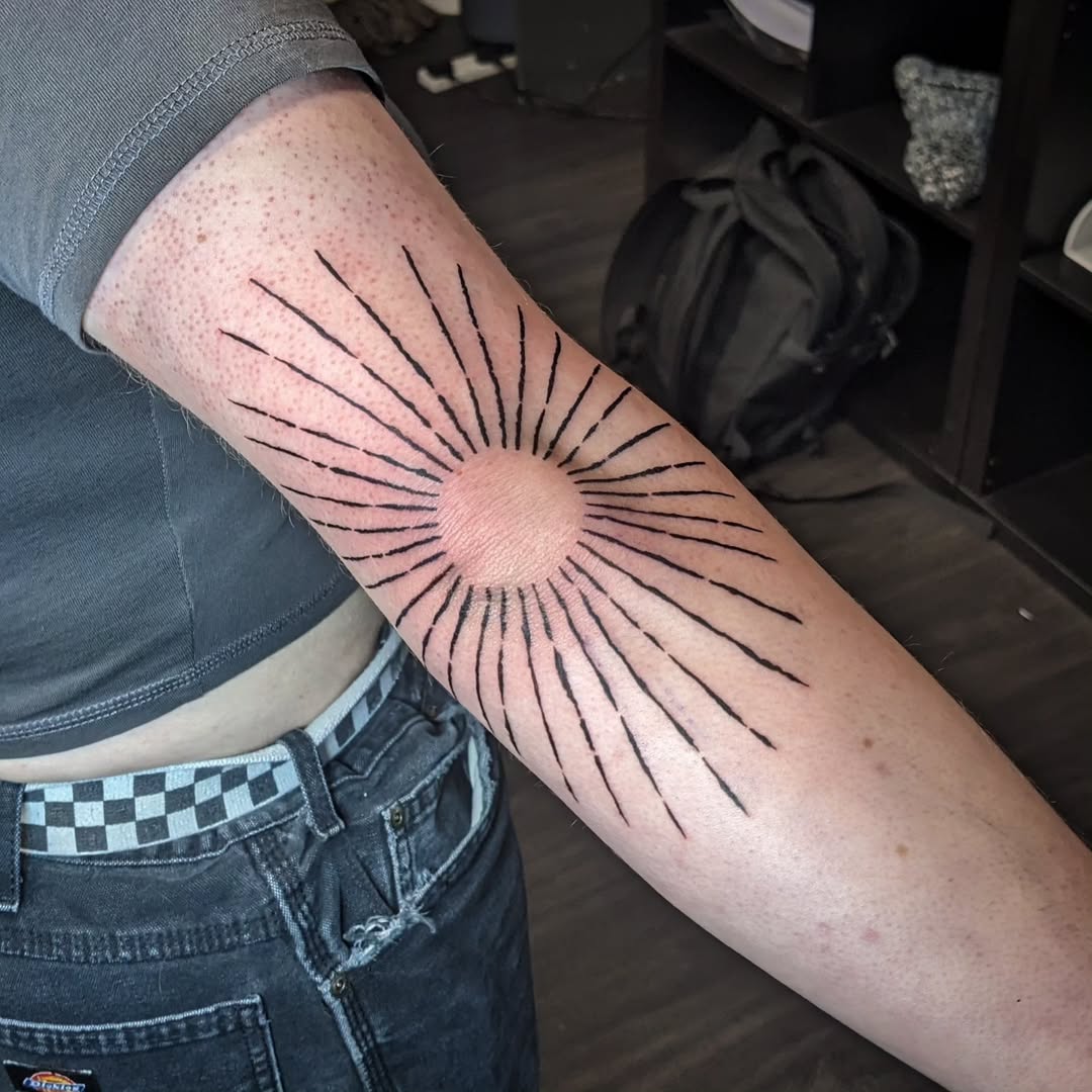 Stunning sunburst elbow tattoo design inspiration