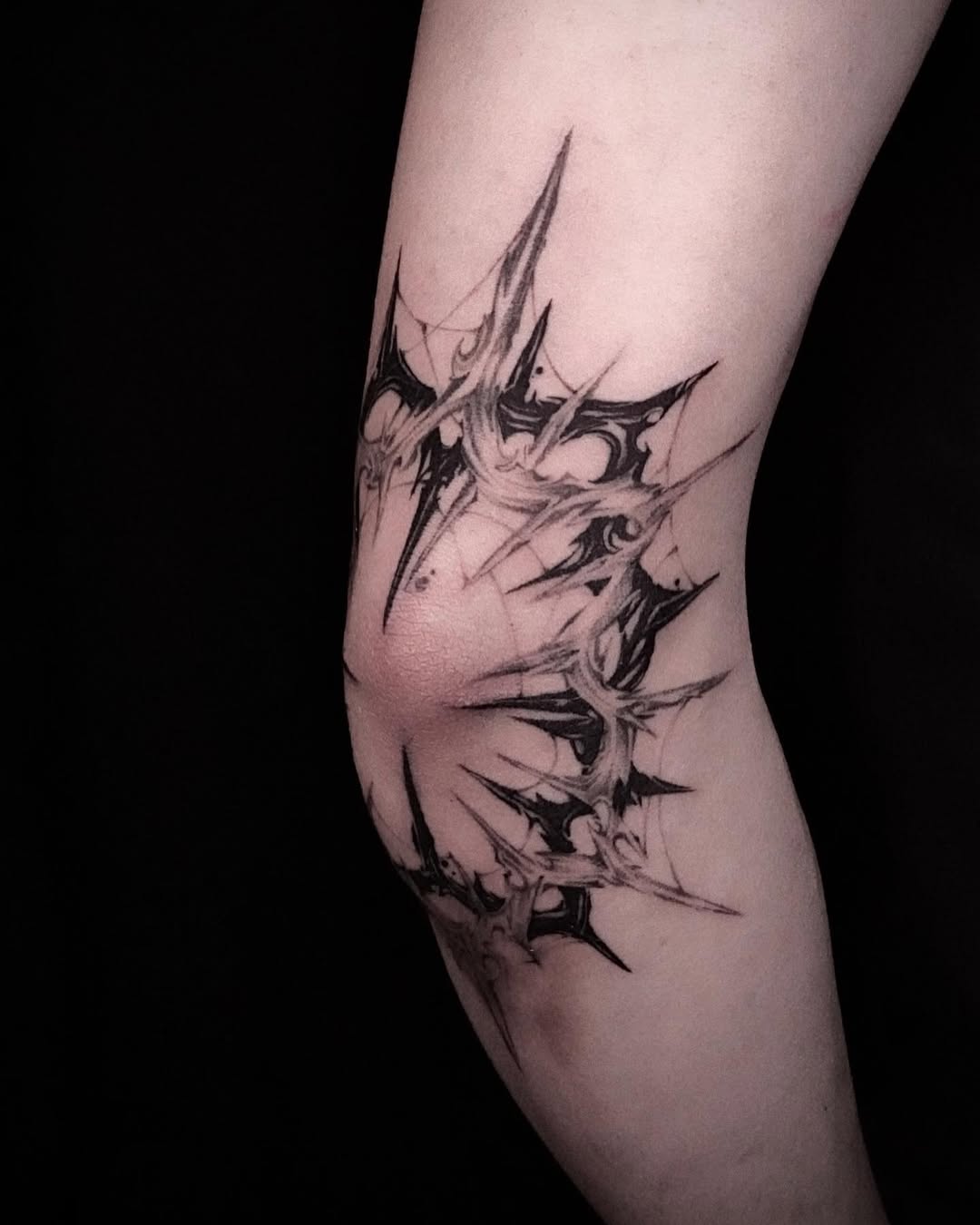 Intricate black ink elbow tattoo design