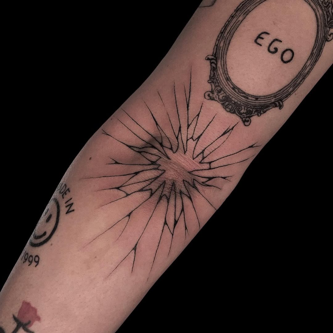 Striking sunburst design on elbow tattoo.