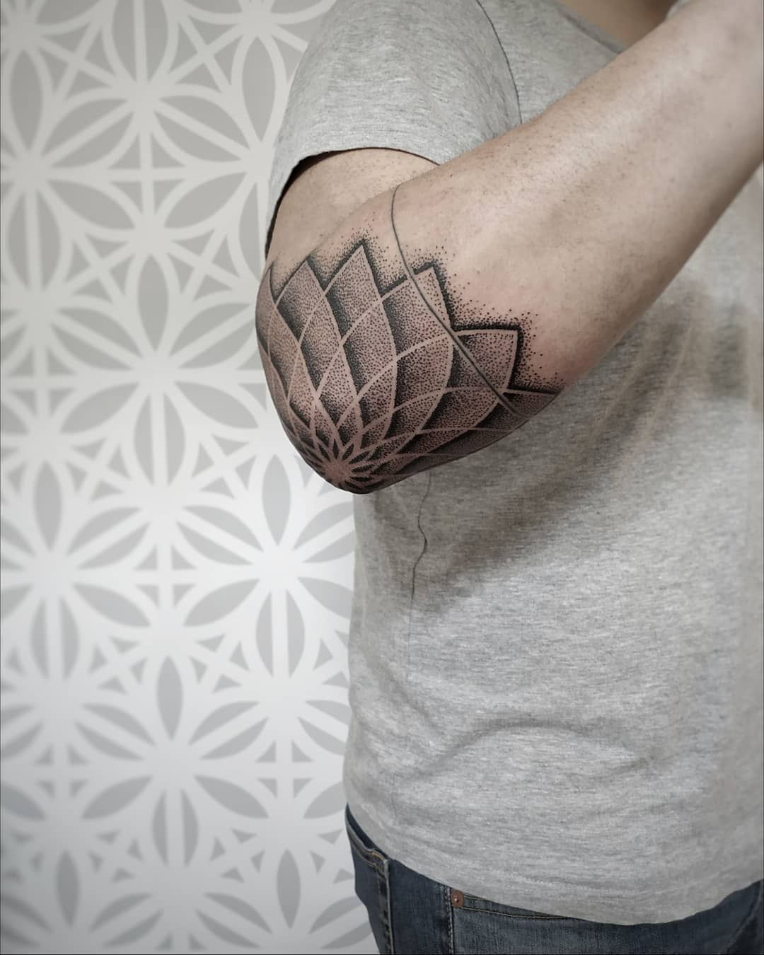 Intricate geometric elbow tattoo showcasing elegance