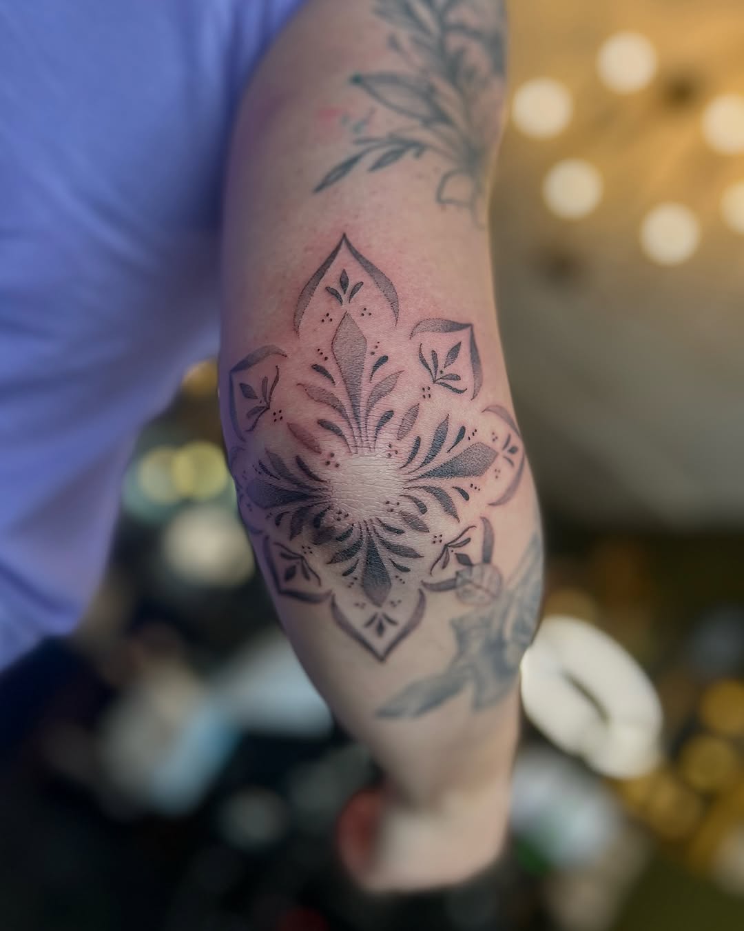 Stunning floral elbow tattoo in black and gray