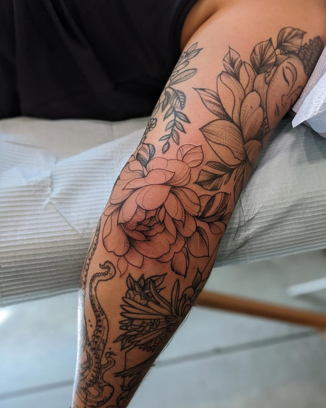 Stunning floral and octopus elbow tattoo design