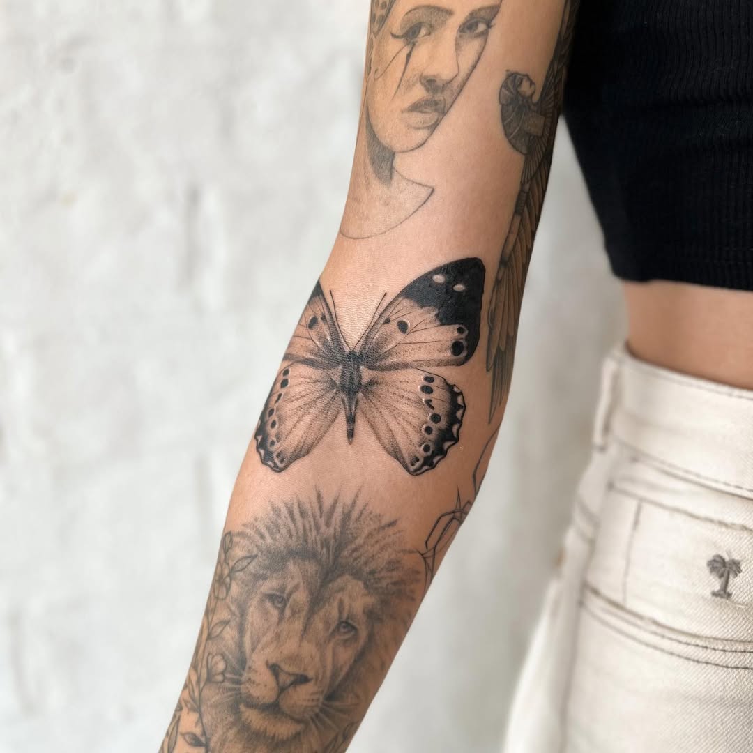 Intricate elbow tattoos with wildlife motifs