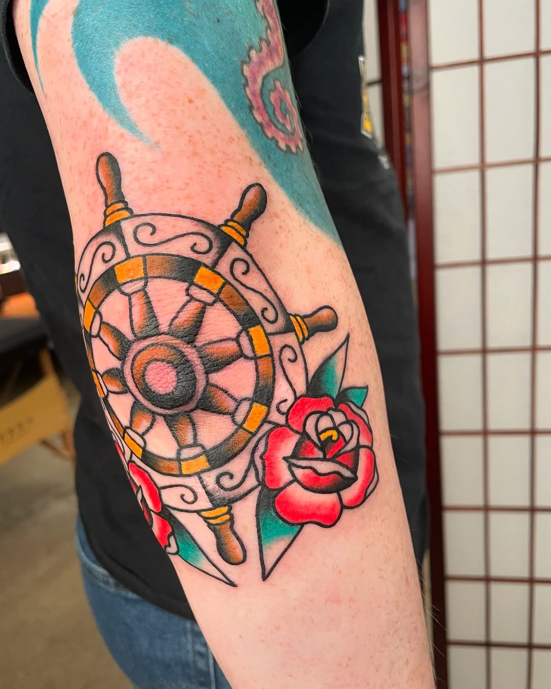 Vibrant Elbow Tattoo Featuring Nautical Elements