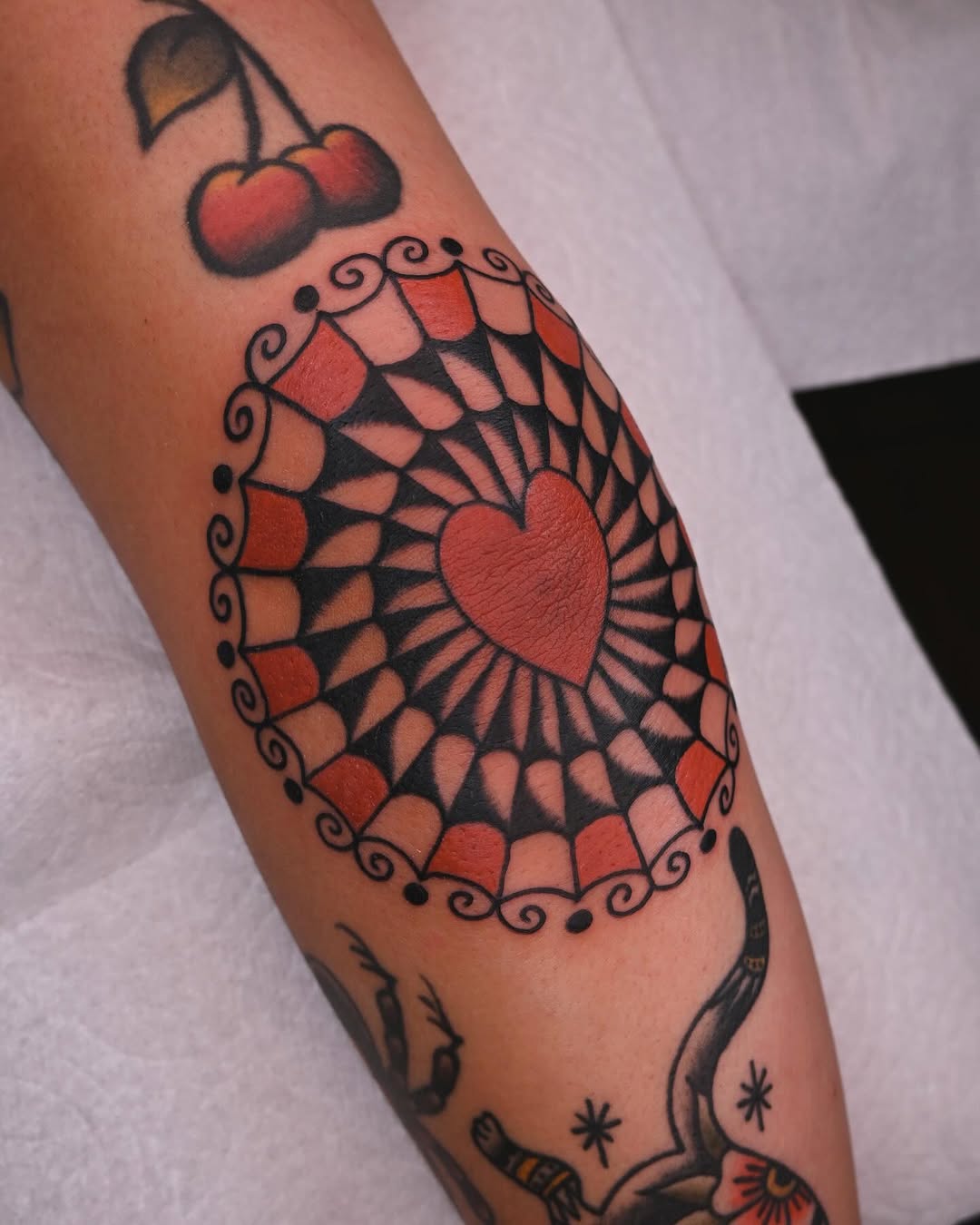 Stylish heart pattern tattoo on elbow.