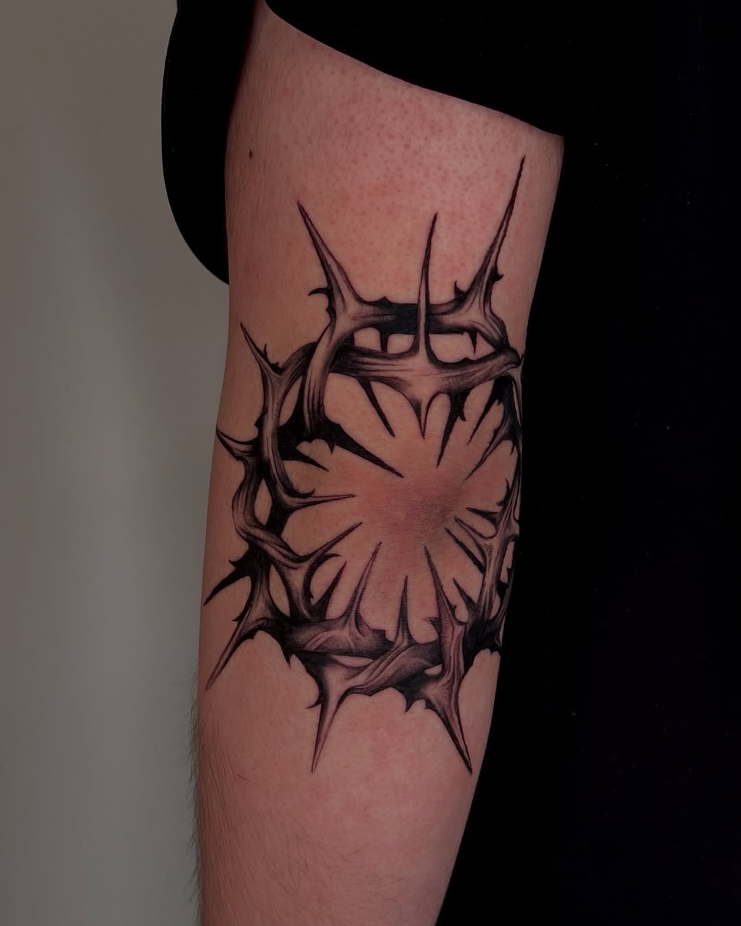 Intricate thorn design on elbow tattoo