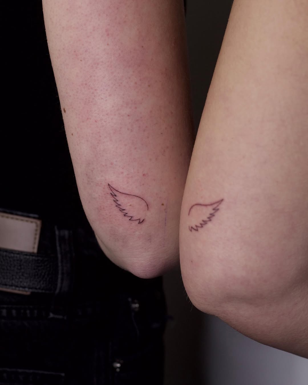 Delicate wing tattoos on the elbows