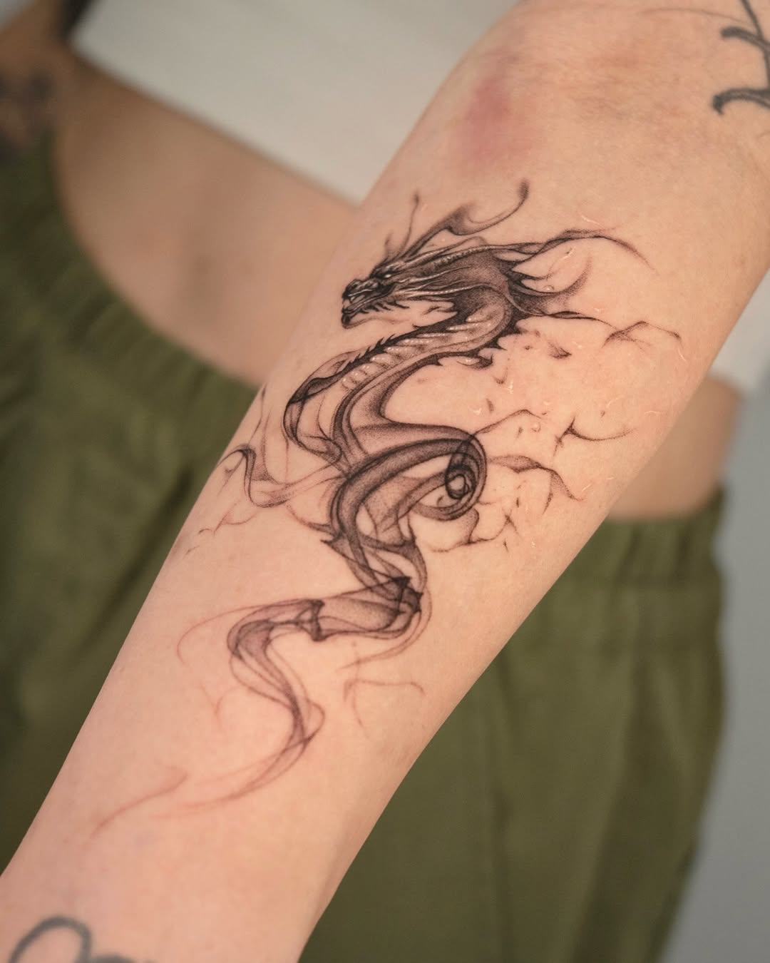 Elegant black dragon tattoo on forearm