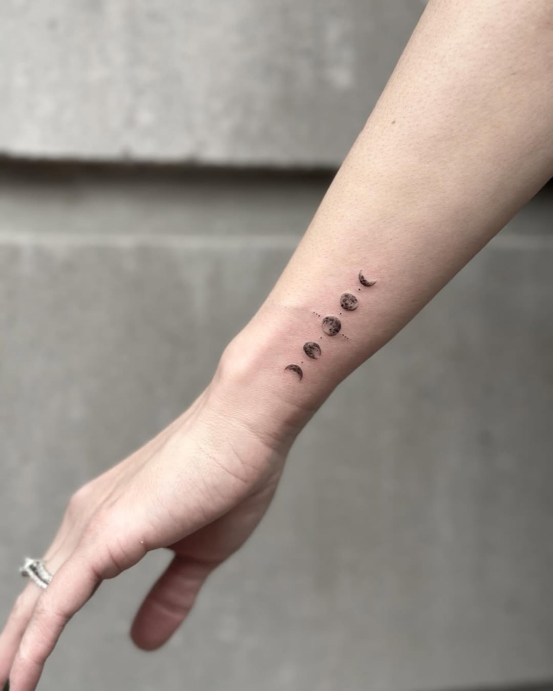 Phases of the moon elegantly inked on skin