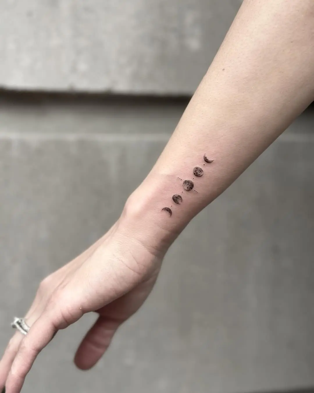 Phases of the moon elegantly inked on skin