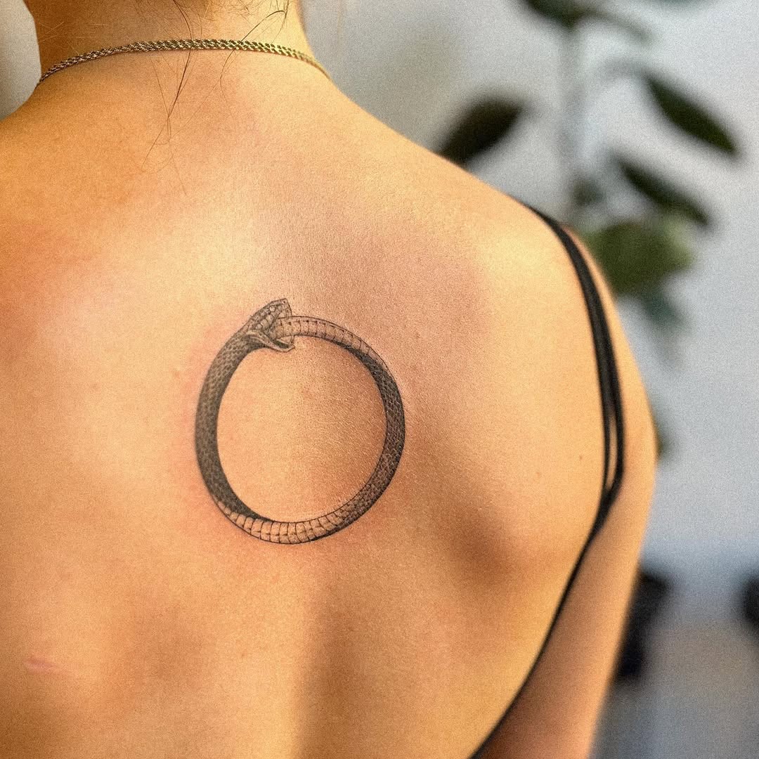 Stylish Ouroboros Tattoo on the Upper Back