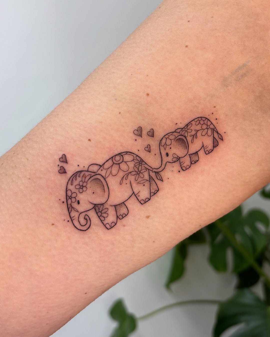 Charming family of floral elephants tattoo