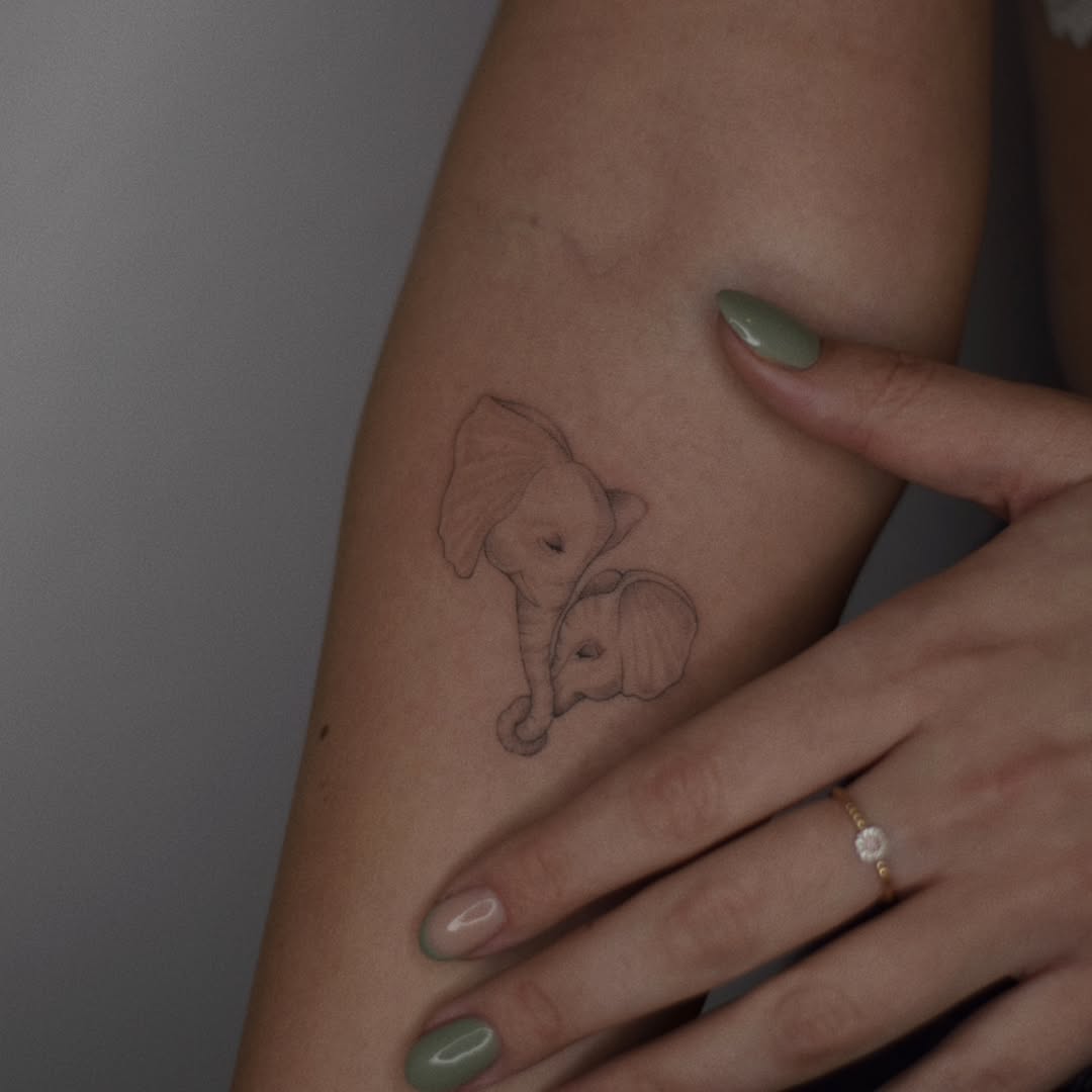 Delicate minimalist elephant tattoo design