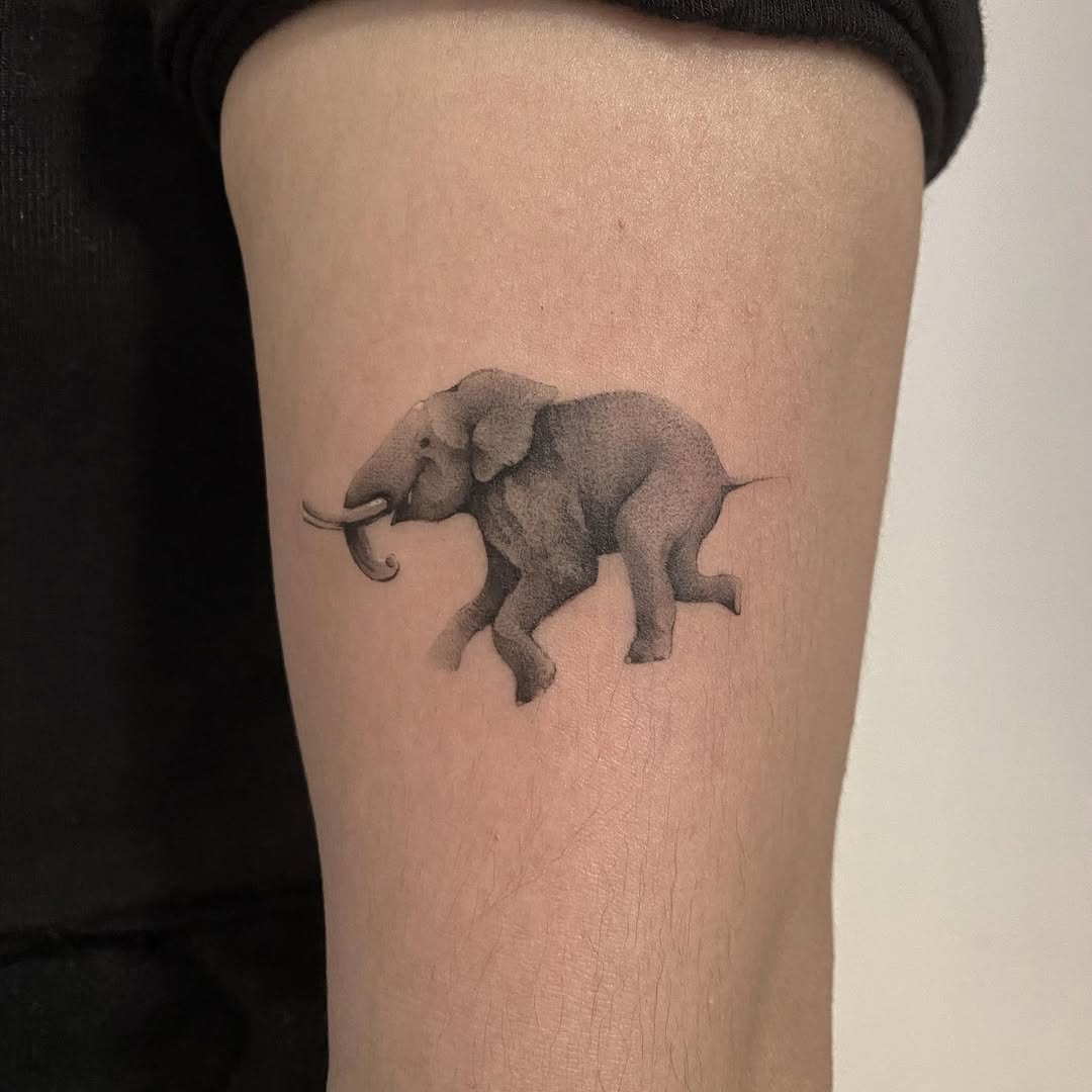 Graceful Running Elephant Tattoo Design