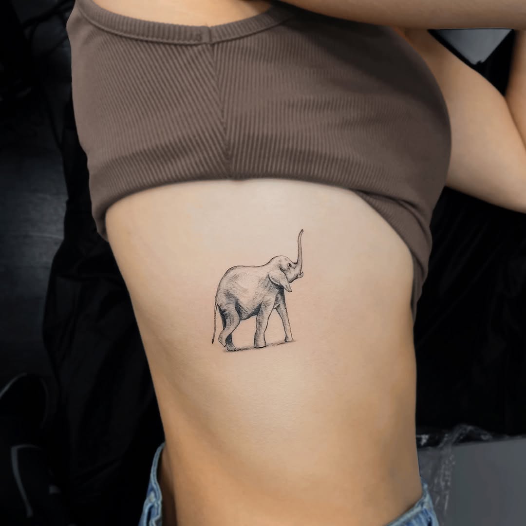 Minimalist elephant tattoo on rib cage