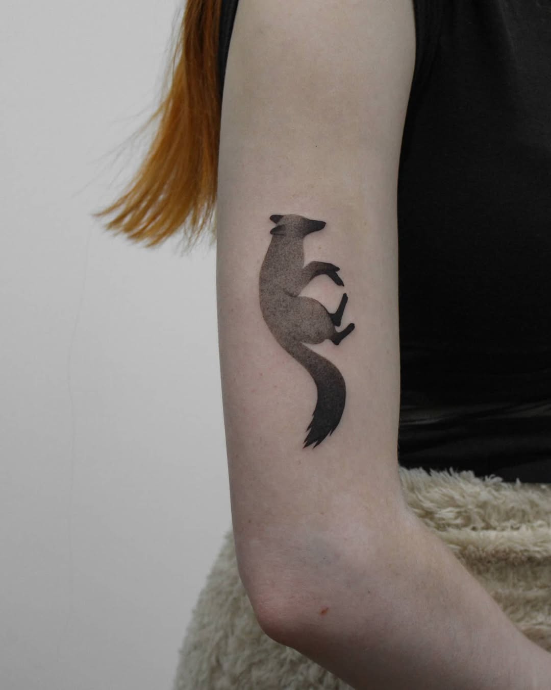 Elegant silhouette of a jumping fox tattoo