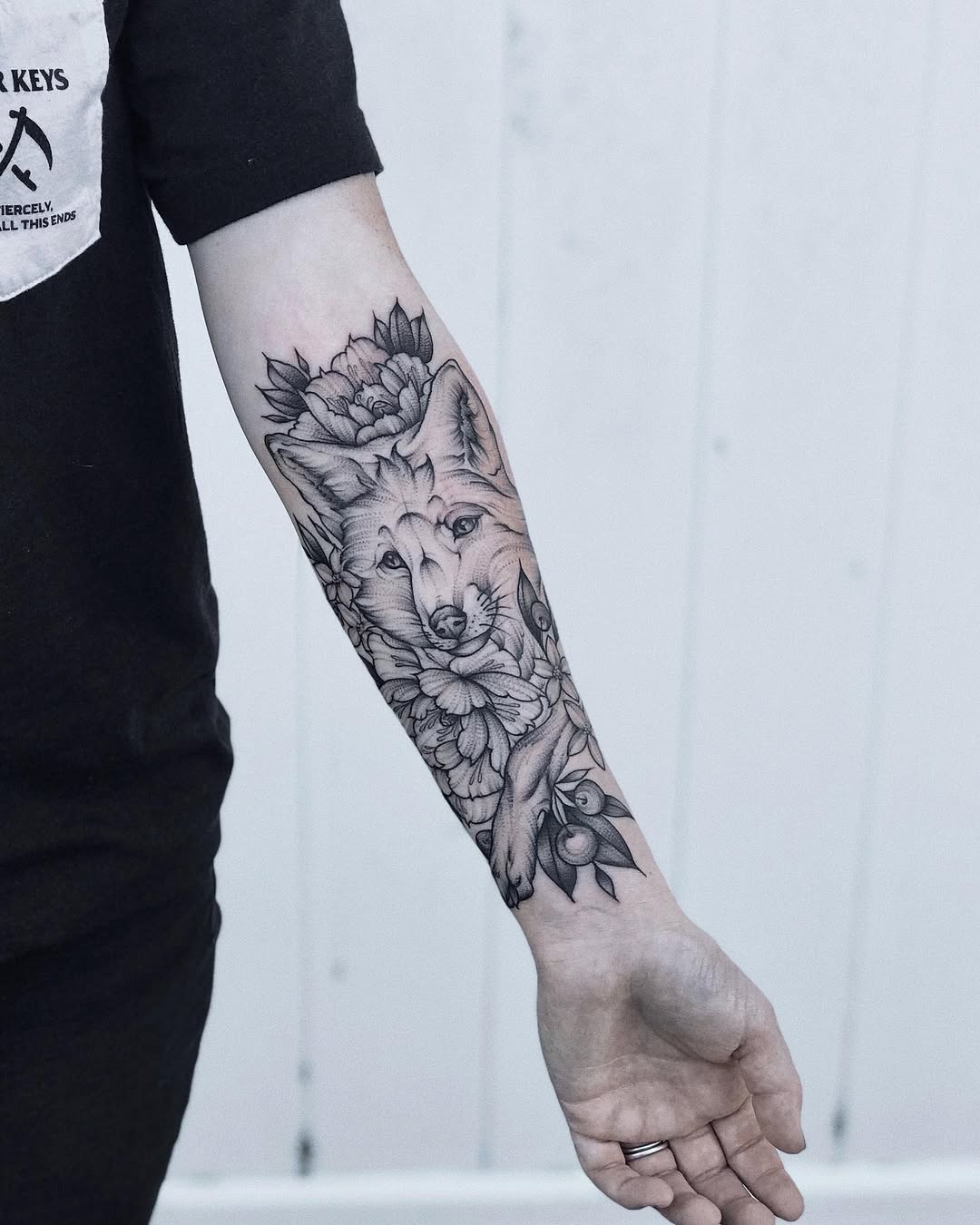 Elegant fox tattoo surrounded by floral elements