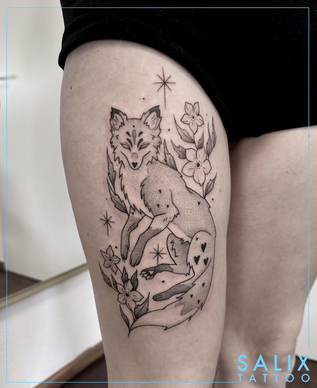 Elegant fox tattoo surrounded by floral elements