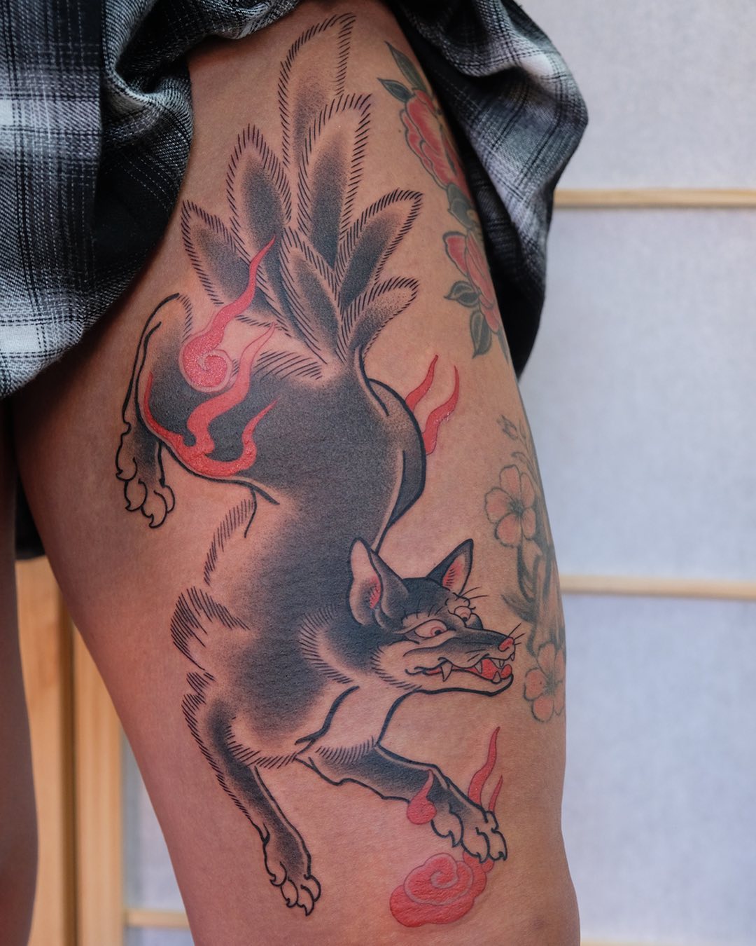 Dynamic Japanese-style fox tattoo design on thigh