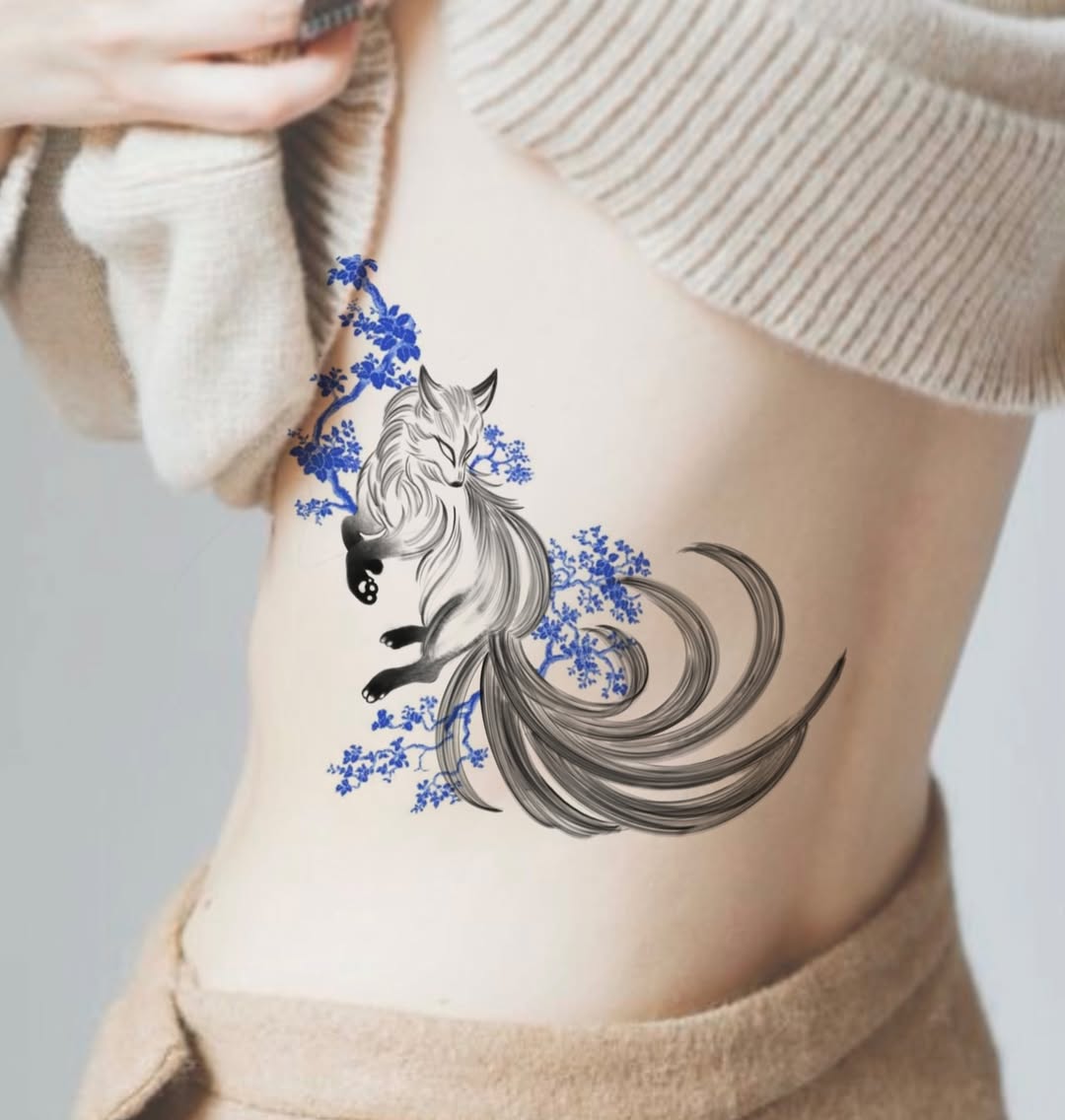 Whimsical fox tattoo with floral elements