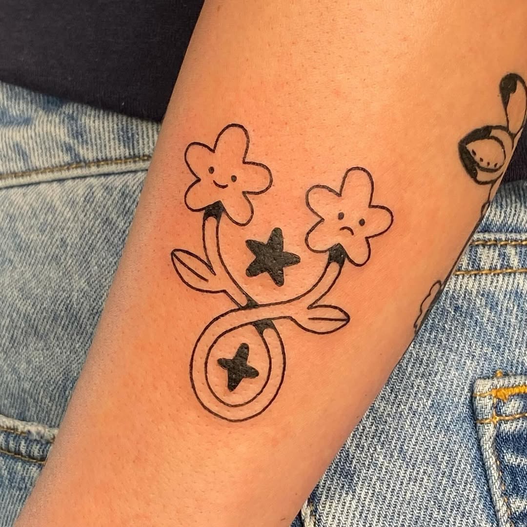 Playful Gemini Tattoo with Floral Elements