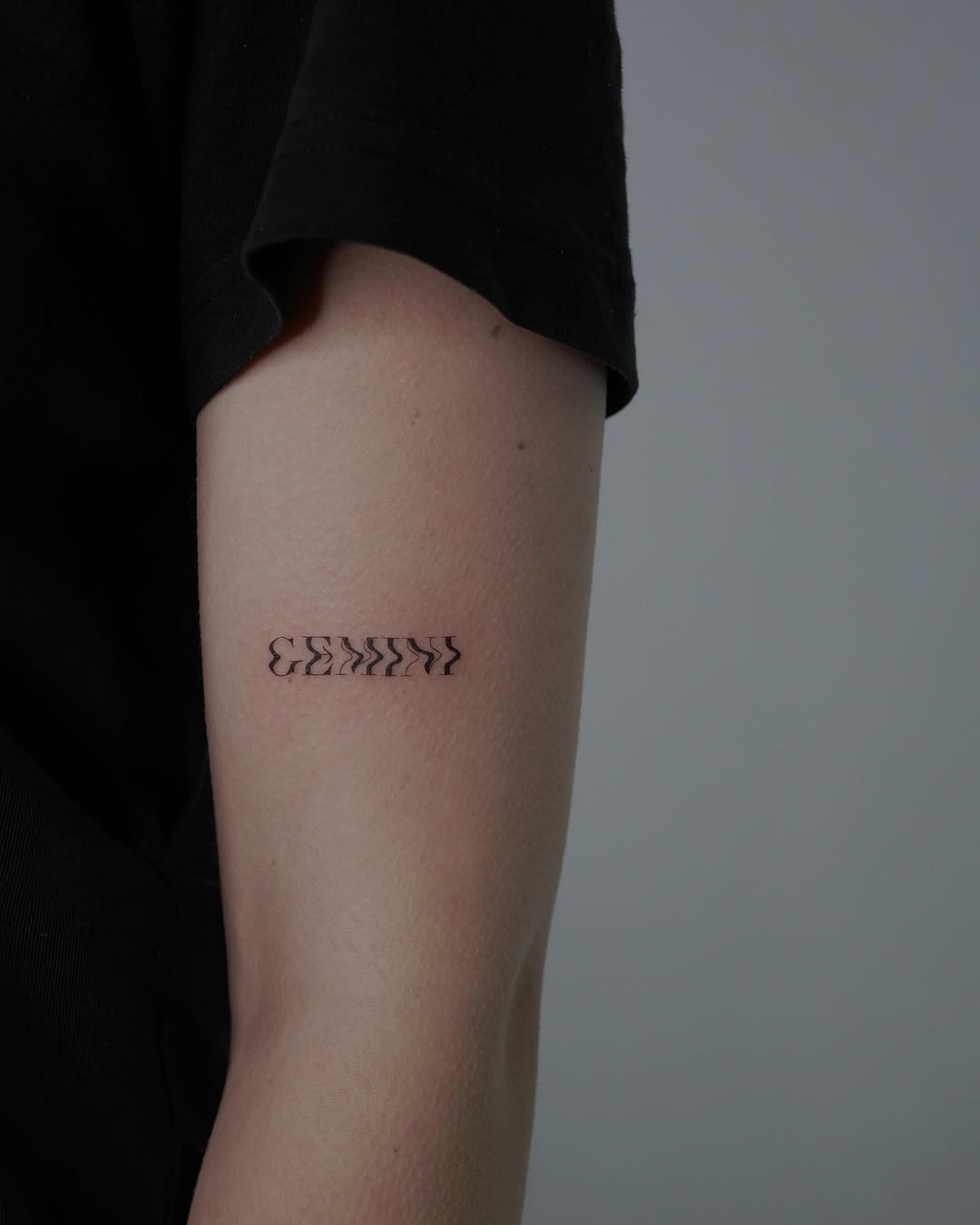 Minimalist Gemini Tattoo on the Forearm