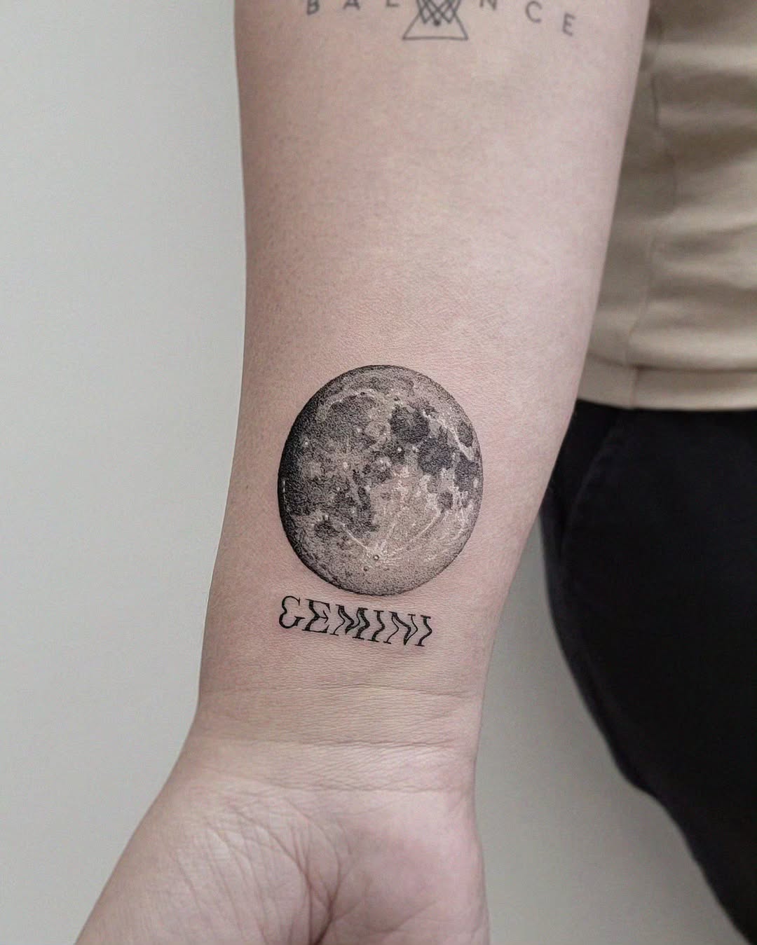 Stylish Gemini moon tattoo on forearm