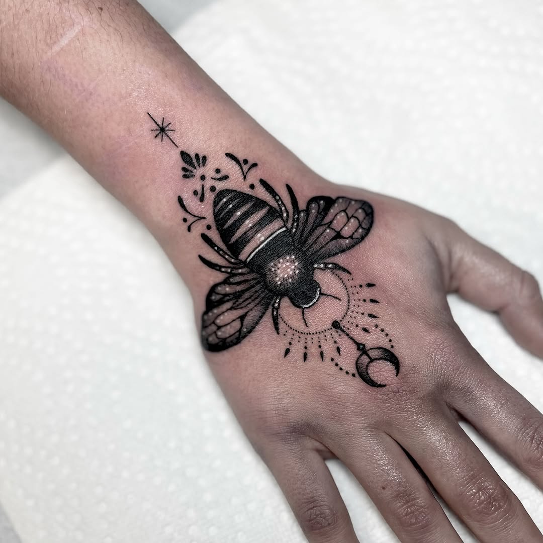 Stunning geometric bumblebee tattoo on hand