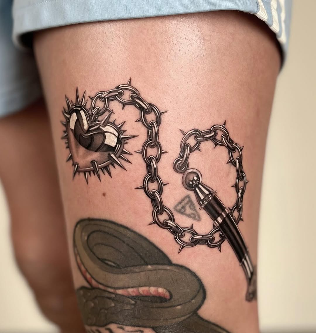 Edgy heart tattoo with chains and spikes