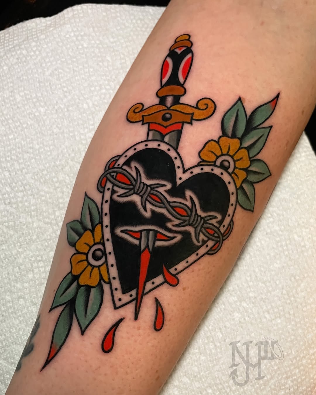 Bold heart tattoo with a striking dagger design