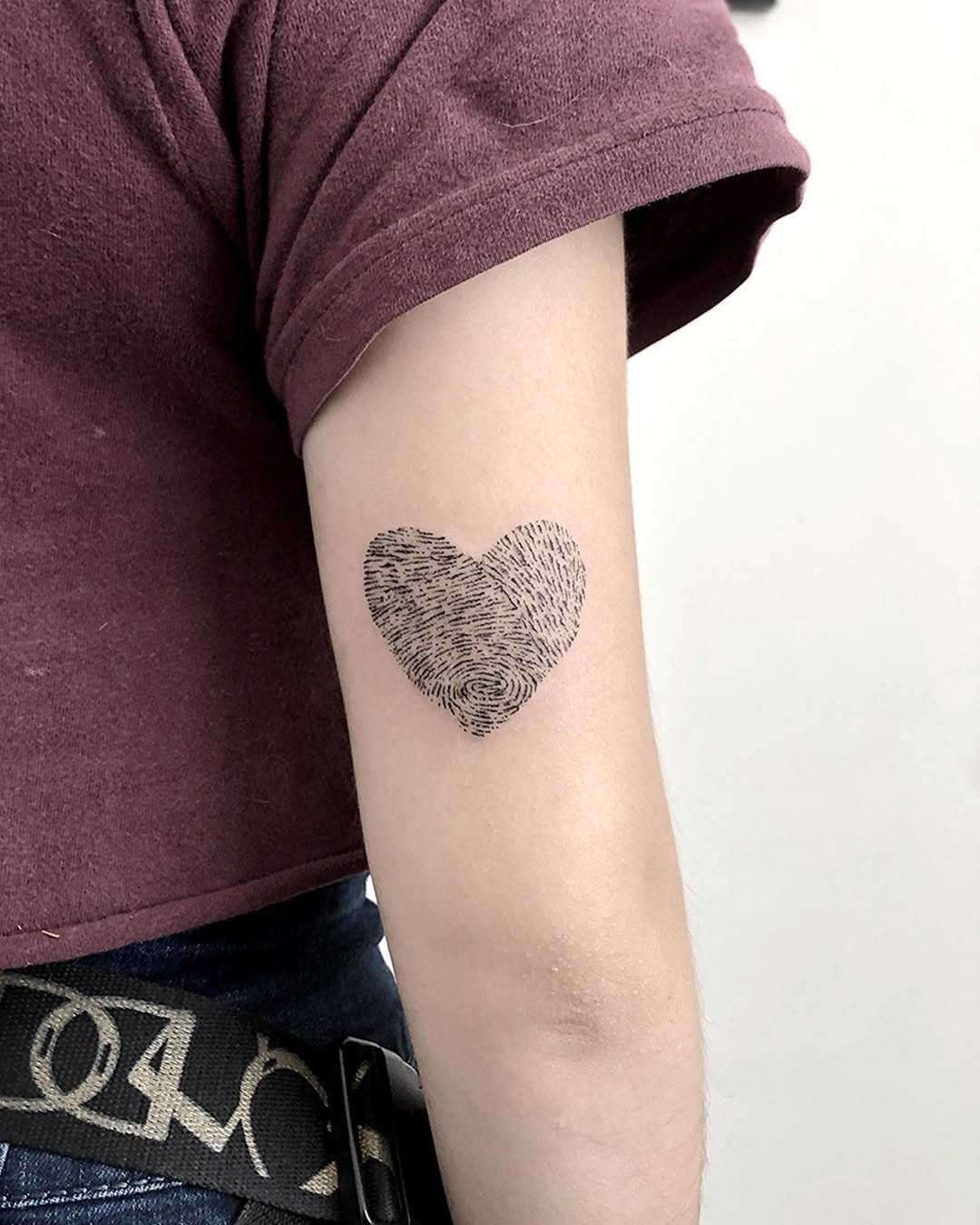 Unique fingerprint heart tattoo on forearm