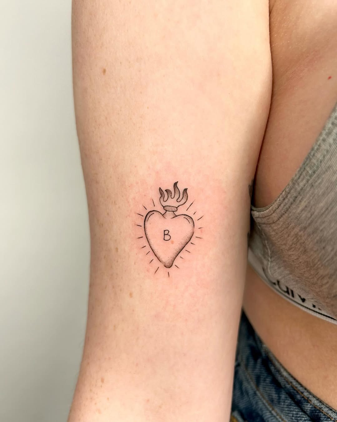 Stylish heart tattoo with flame design