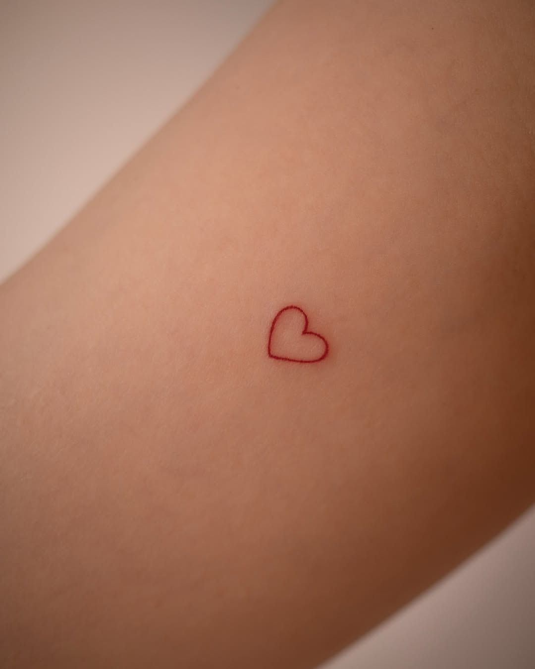 Stylish minimalistic heart tattoo design