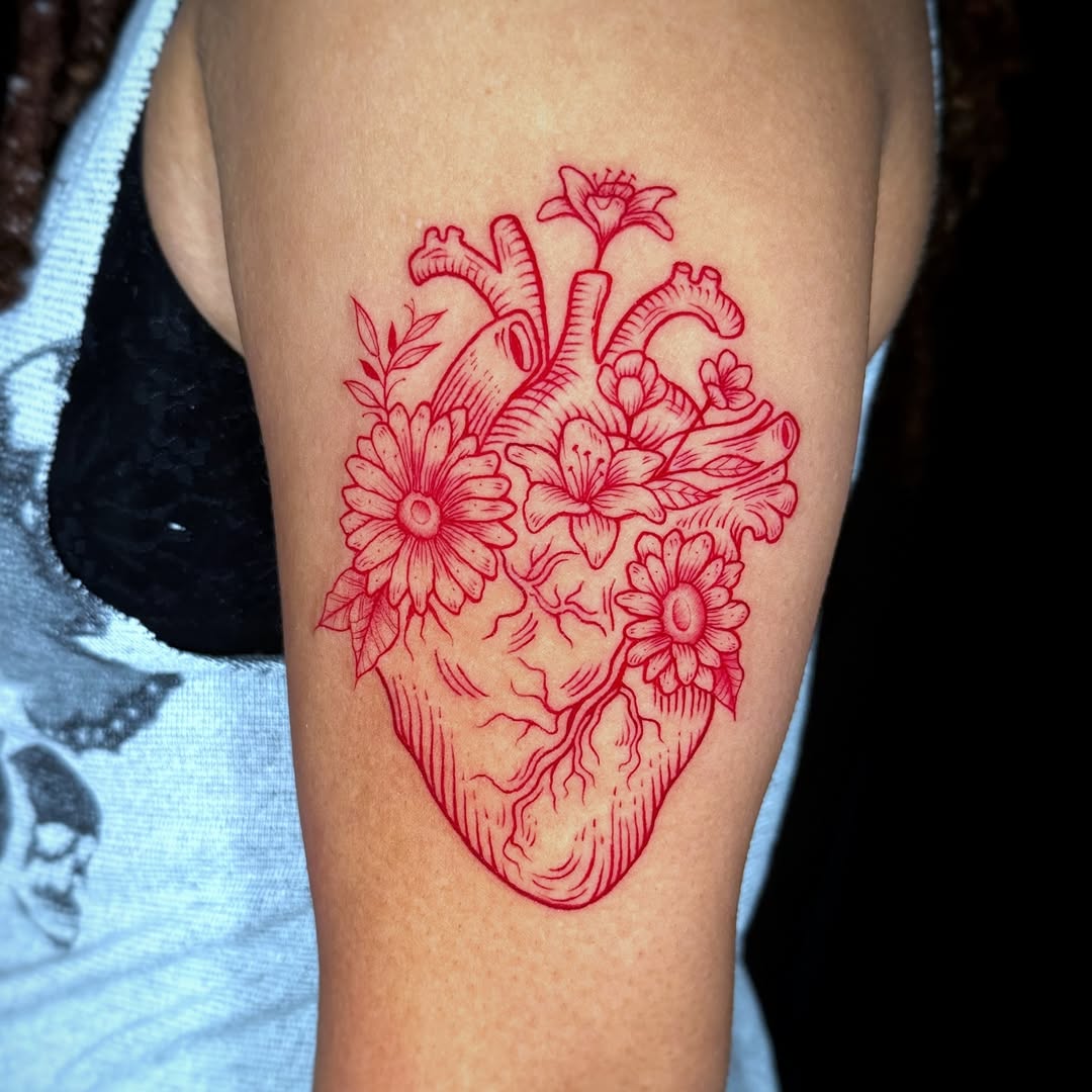 Vibrant heart tattoo with floral elements