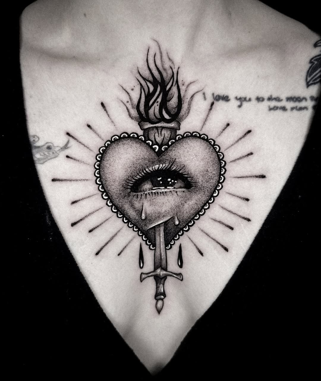 Intricate heart tattoo with bold symbolism.