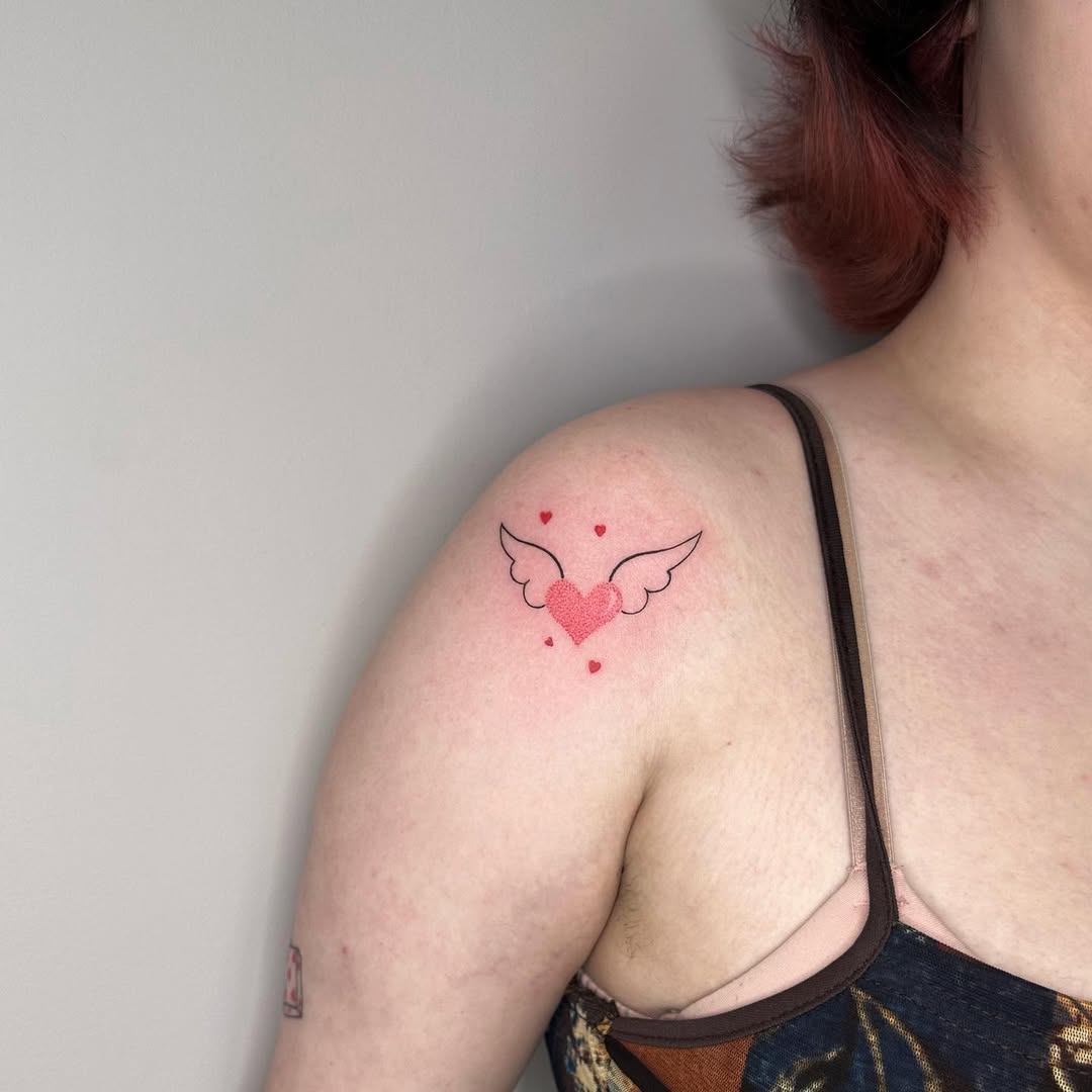 Whimsical heart tattoo with angel wings