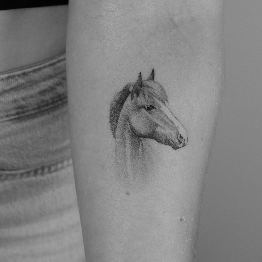 Elegant black and white horse tattoo design