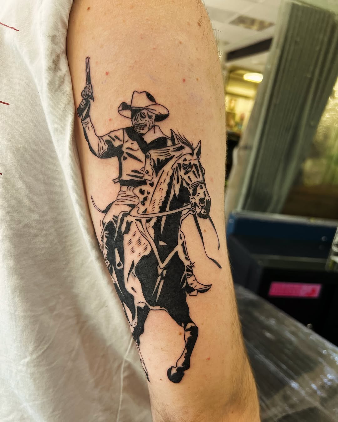 Dynamic cowboy skeleton tattoo on horseback