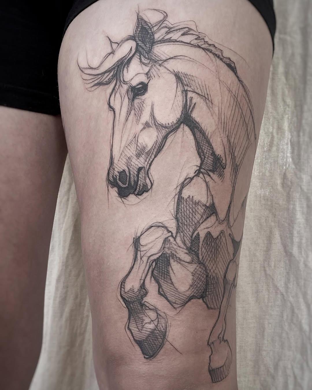 Stylized sketch of a rearing horse tattoo