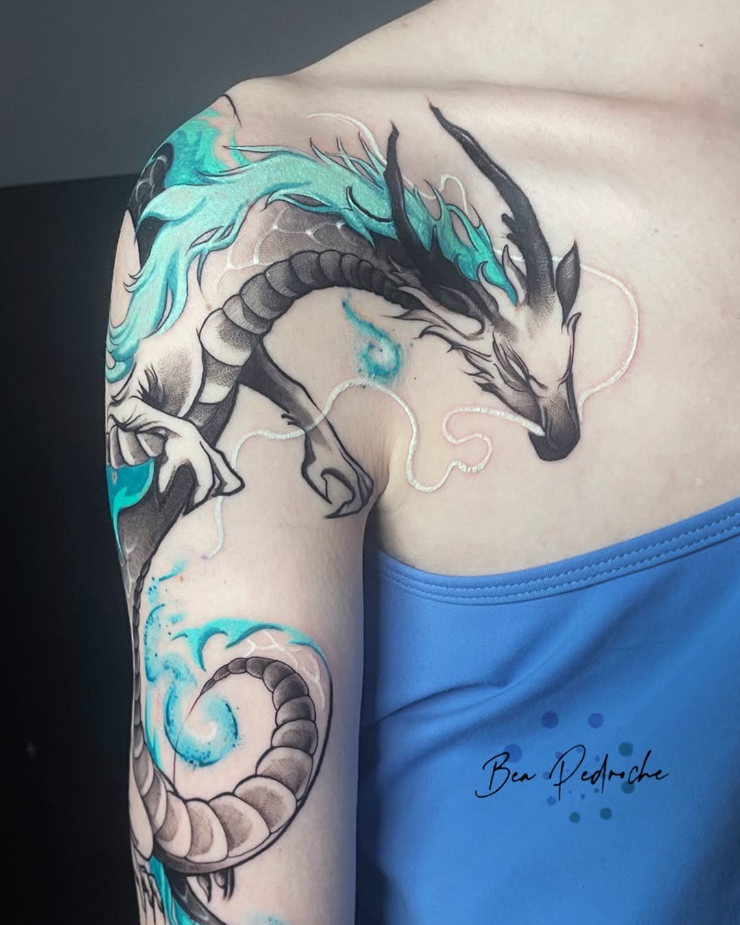 Stunning dragon tattoo with aqua accents