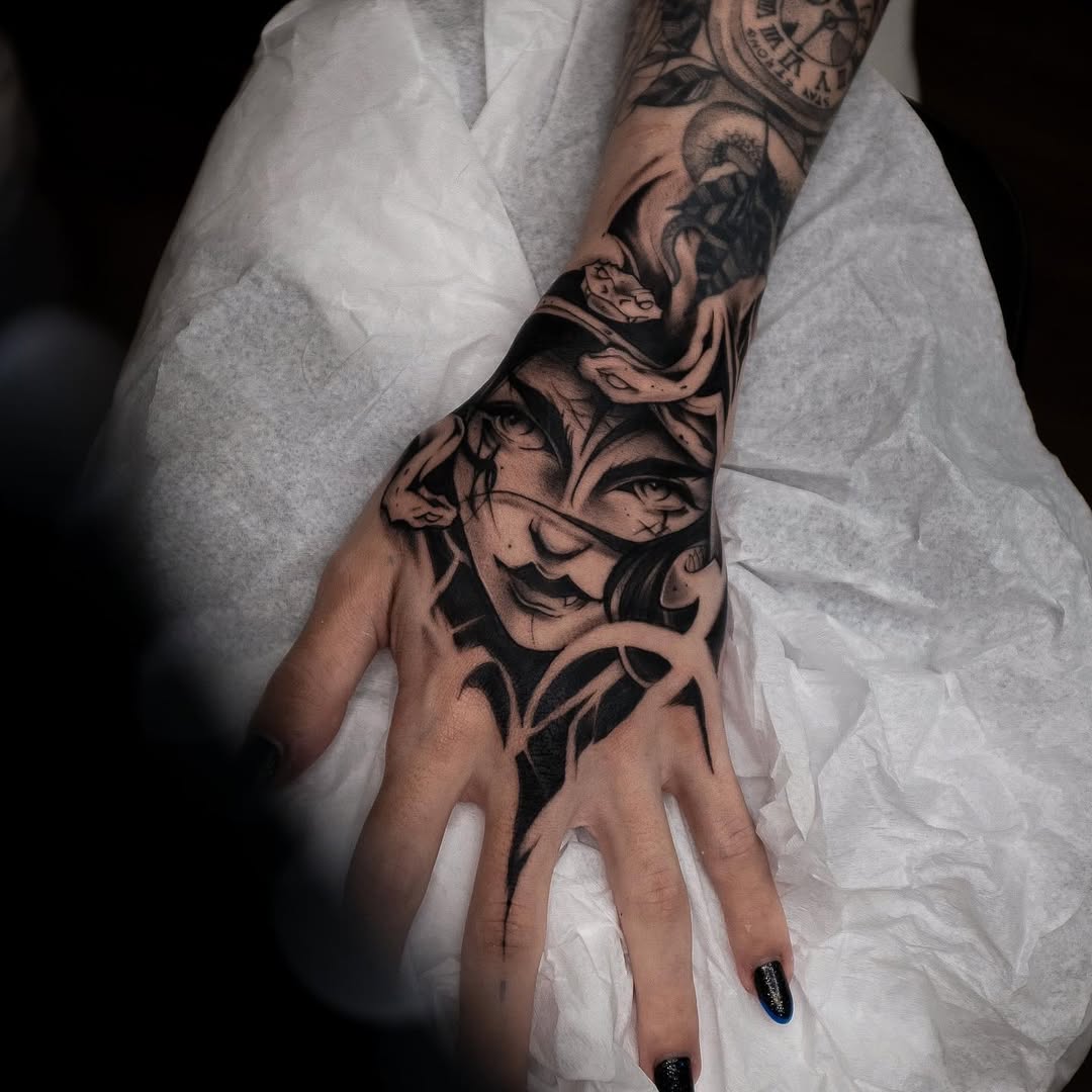 Striking Medusa Hand Tattoo with Intricate Details