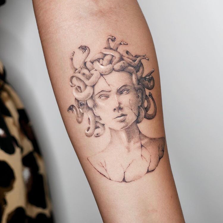 Intricate tattoos featuring classic Medusa imagery.