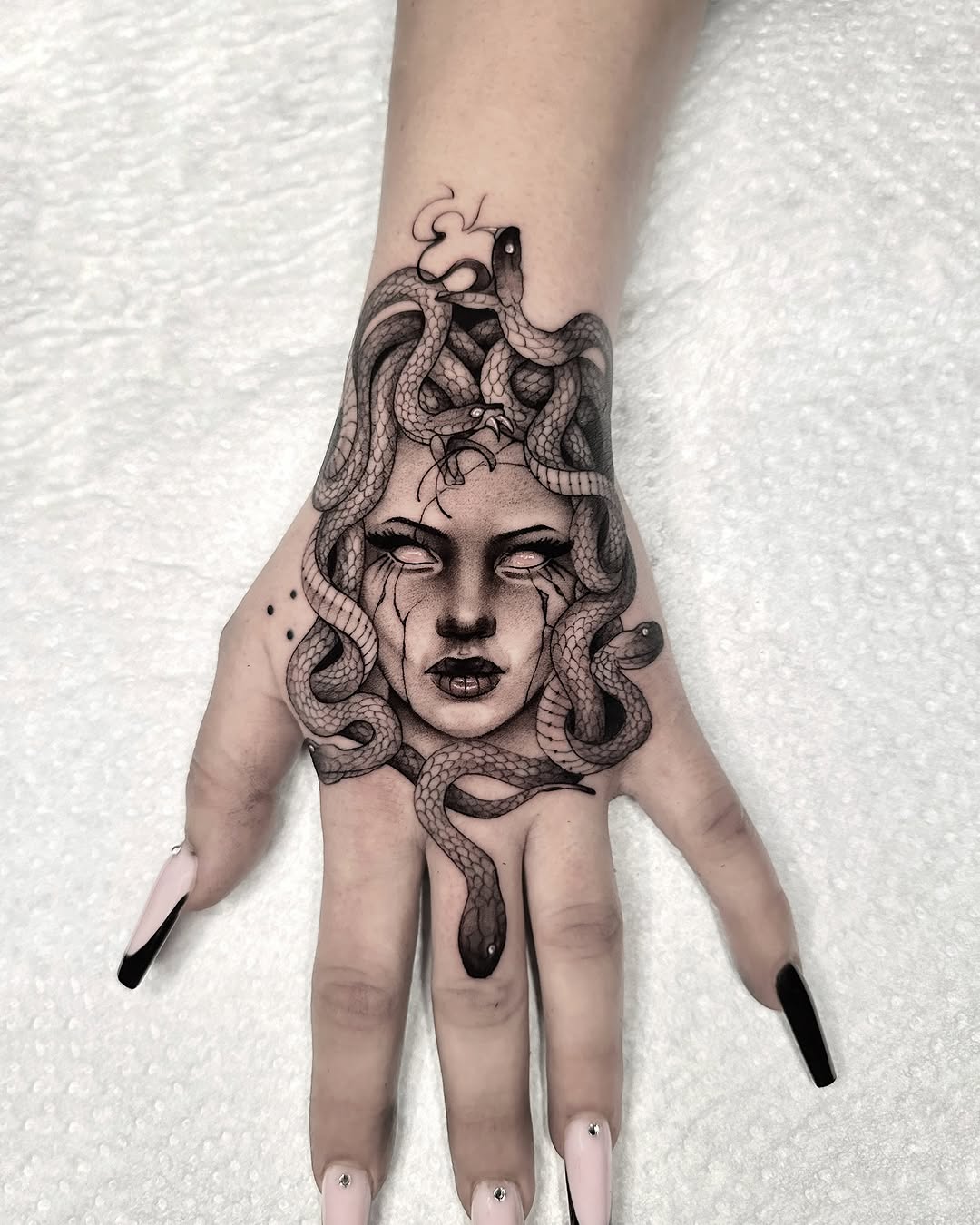 Intricate Medusa Hand Tattoo with Snakes