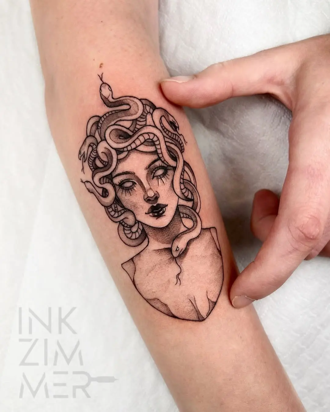 Striking Medusa tattoo with snake details