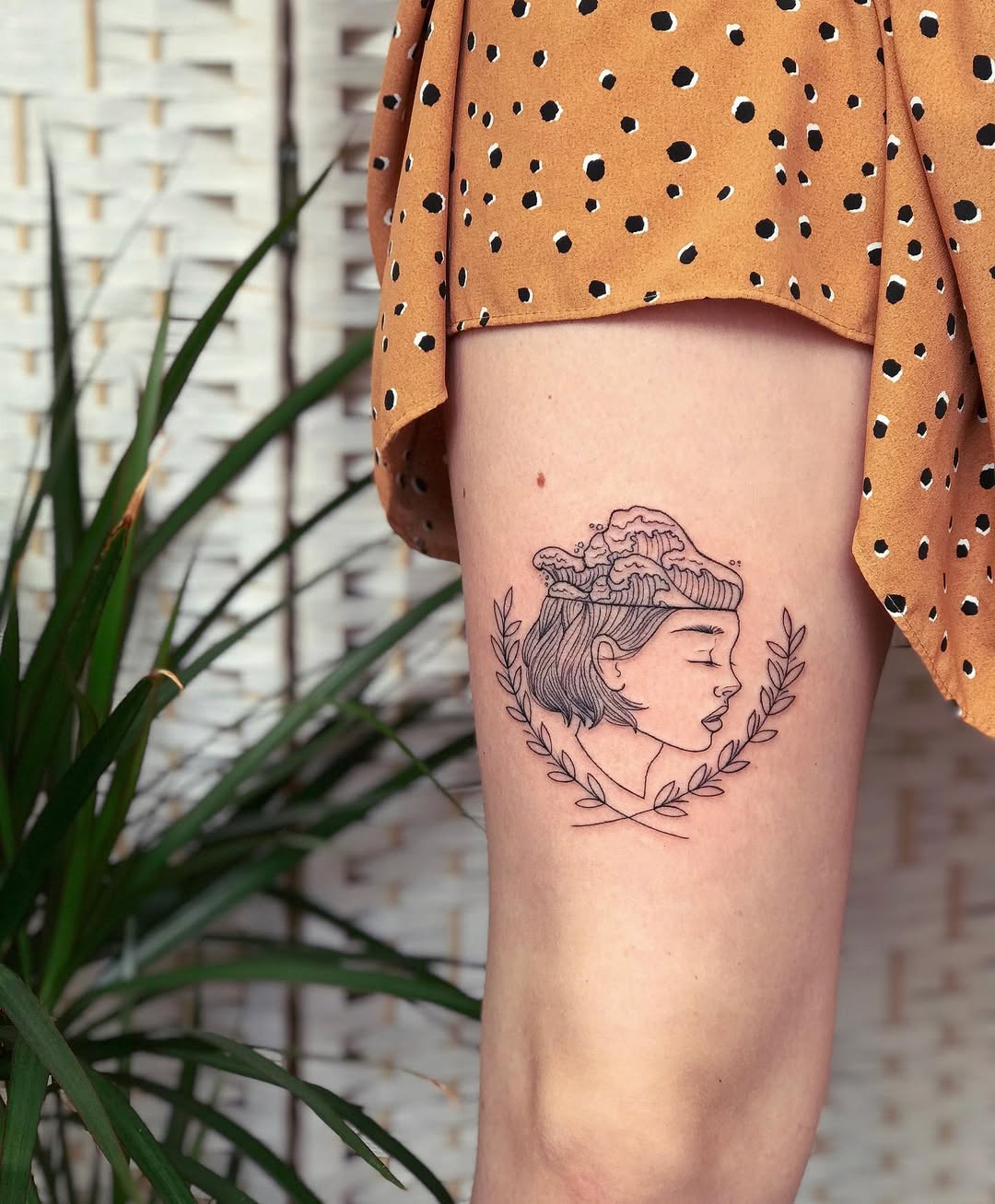 Elegant woman profile surrounded by a laurel wreath