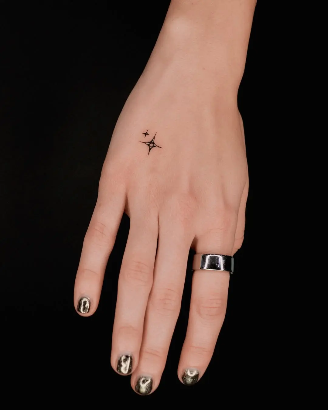Elegant minimalistic star tattoo on hand