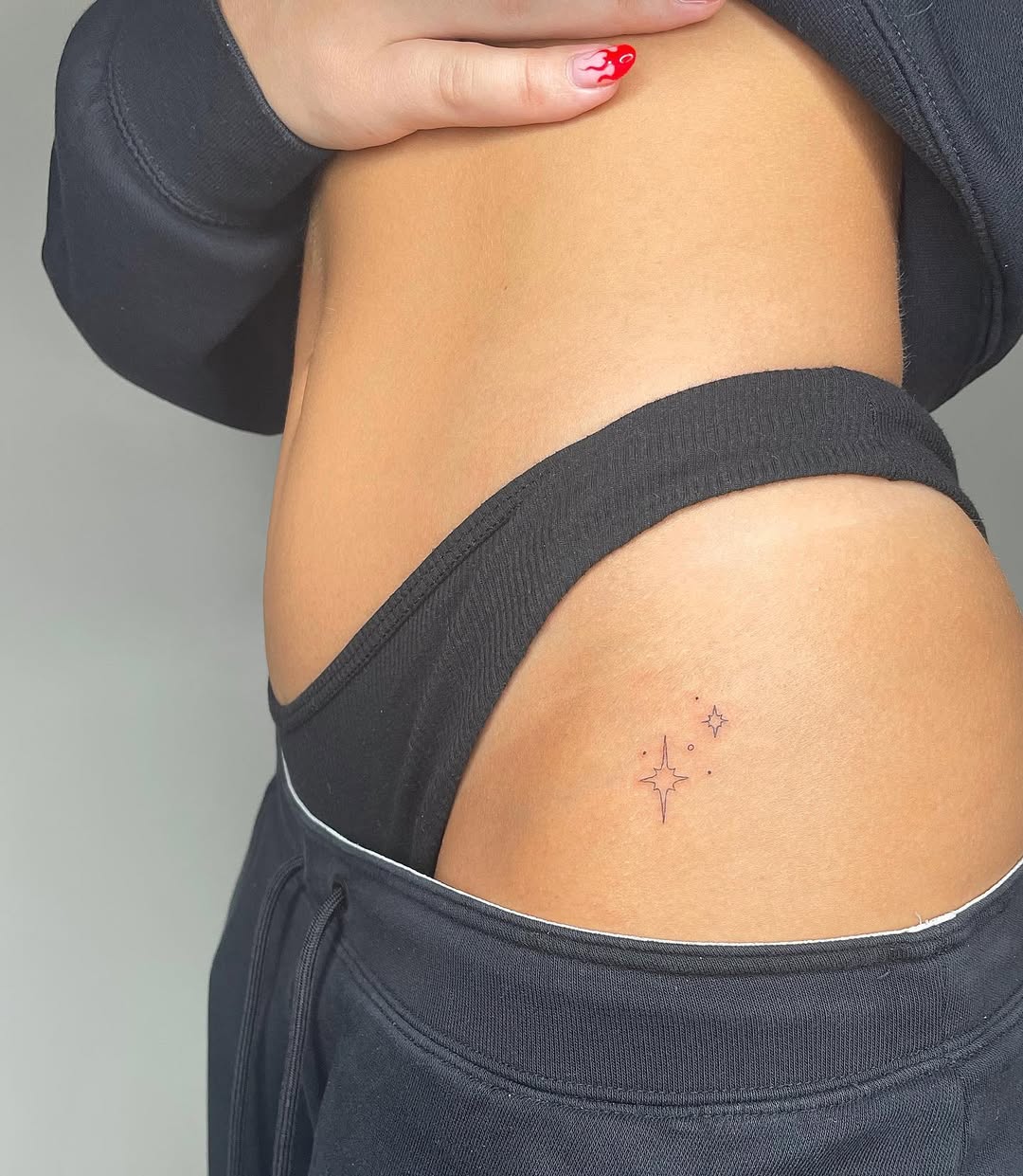 Charming minimalist star tattoo on hip