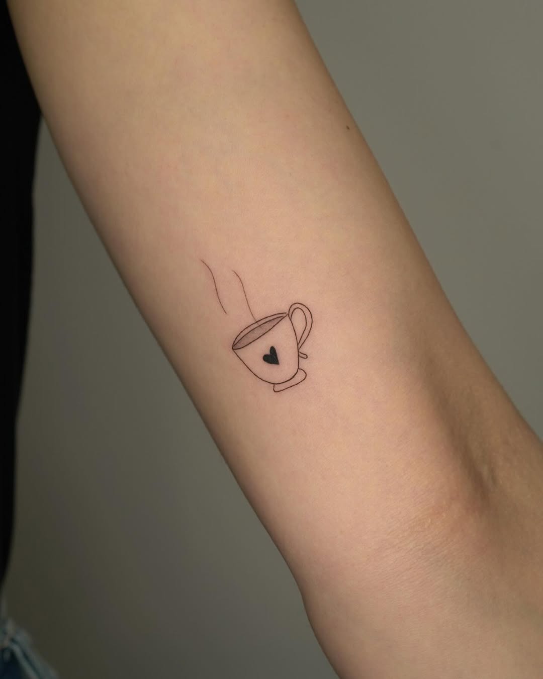 Charming minimalist coffee cup tattoo design